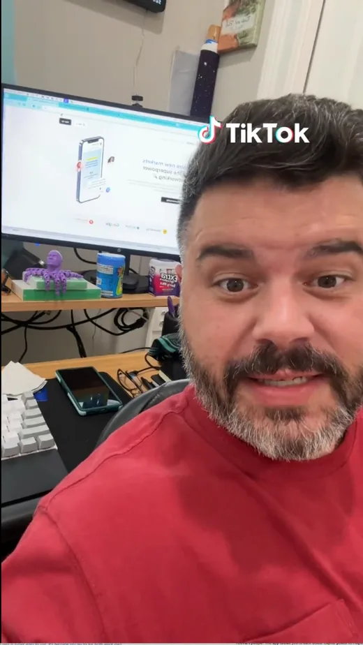 Frame from a TikTok video in which a creator shows the Intch professional networking website on his monitor.